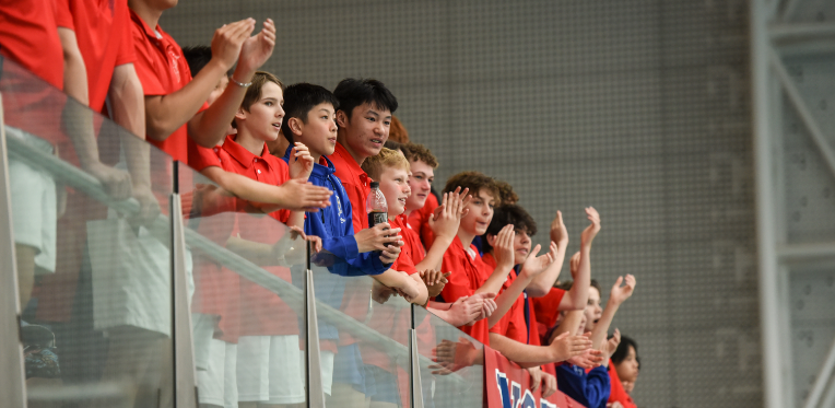 Students at a sporting event cheering