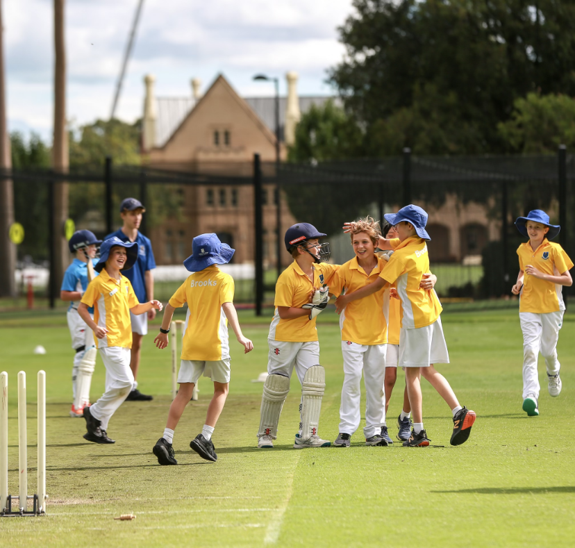 Student playing cricket celebrating