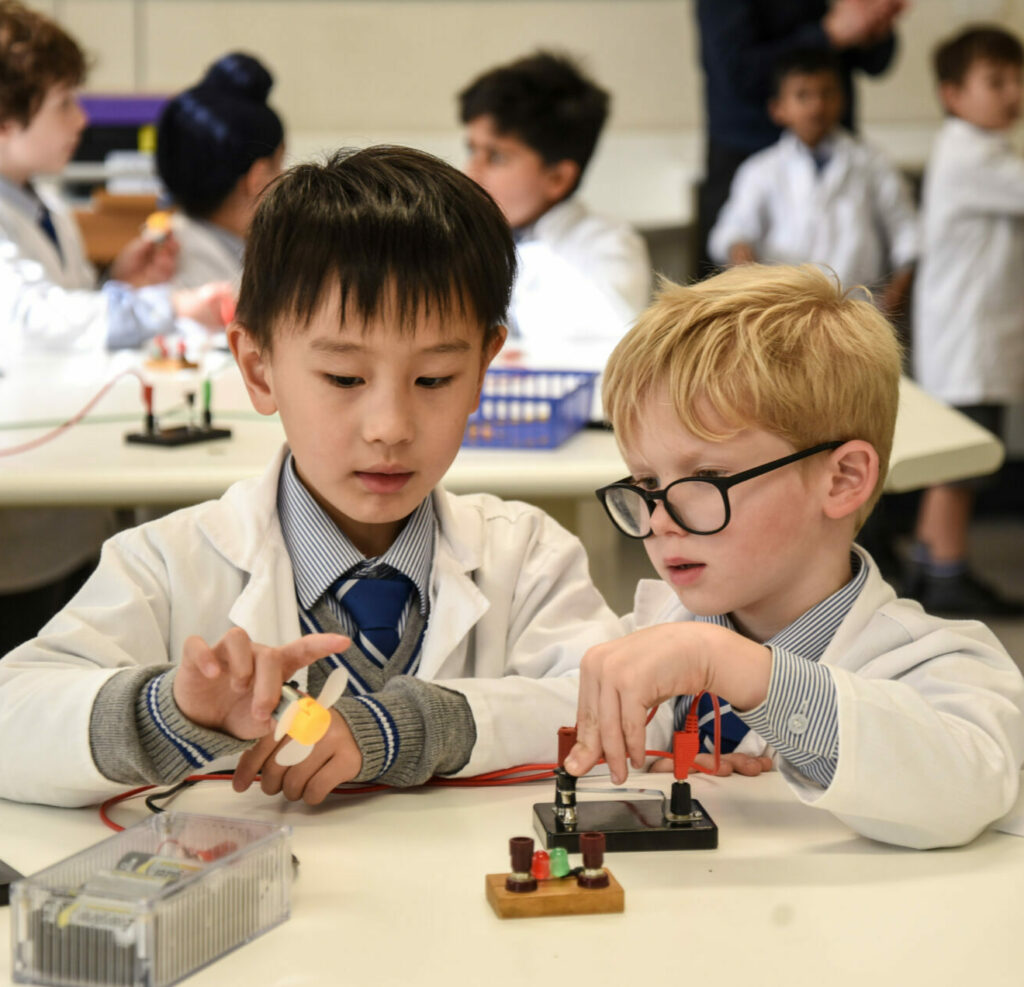Two junior school boys experimenting in the science lab