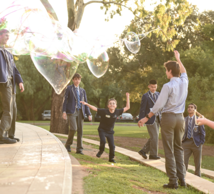 Students playing with bubbles outside