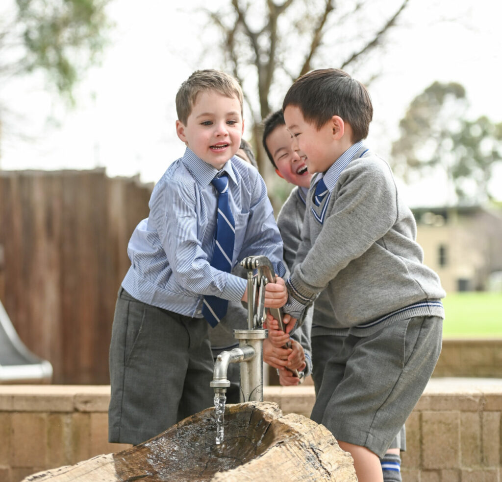 Boys playing with a tap