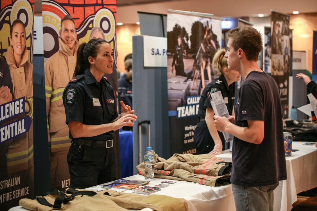 a fire fighter talking to a student about careers