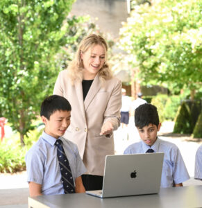 Teachers and students working outside on their laptops